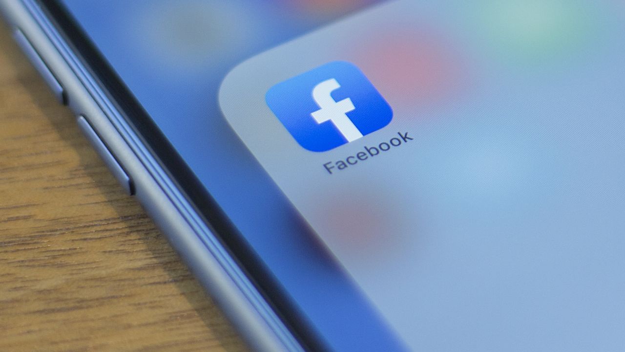 The Facebook logo is seen on a phone in this photo illustration in Washington, DC, on July 10, 2019.