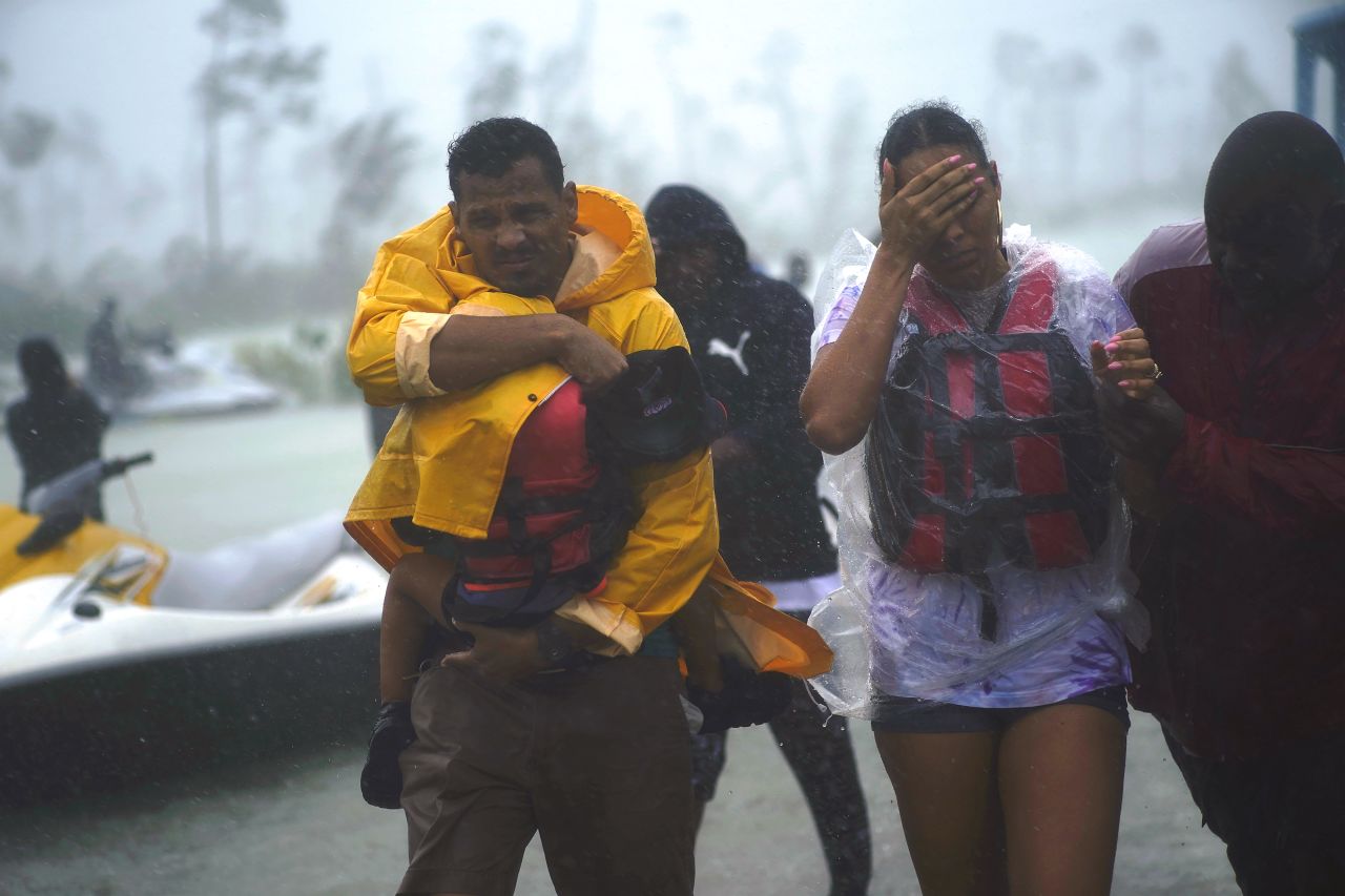 A family is escorted to a safe zone after being rescued in Freeport, Bahamas, on September 3.