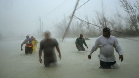 Volunteers tried to rescue families Tuesday in Freeport, on the island of Grand Bahama. 