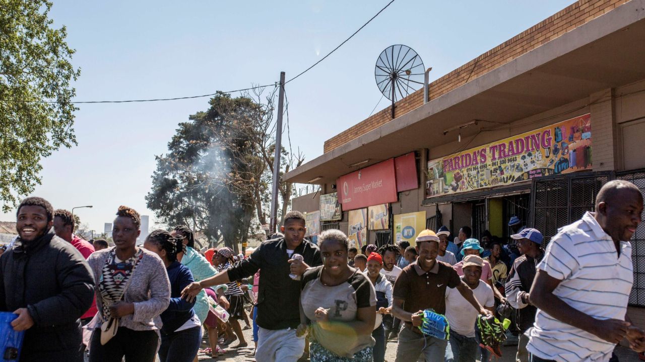Looters run from a shop in Turffontein, east of Johannesburg, on September 2, 2019.