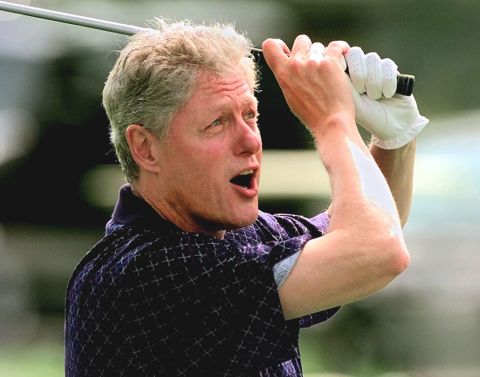 Clinton tees off while playing golf at Martha's Vineyard in Massachusetts in August 1997.