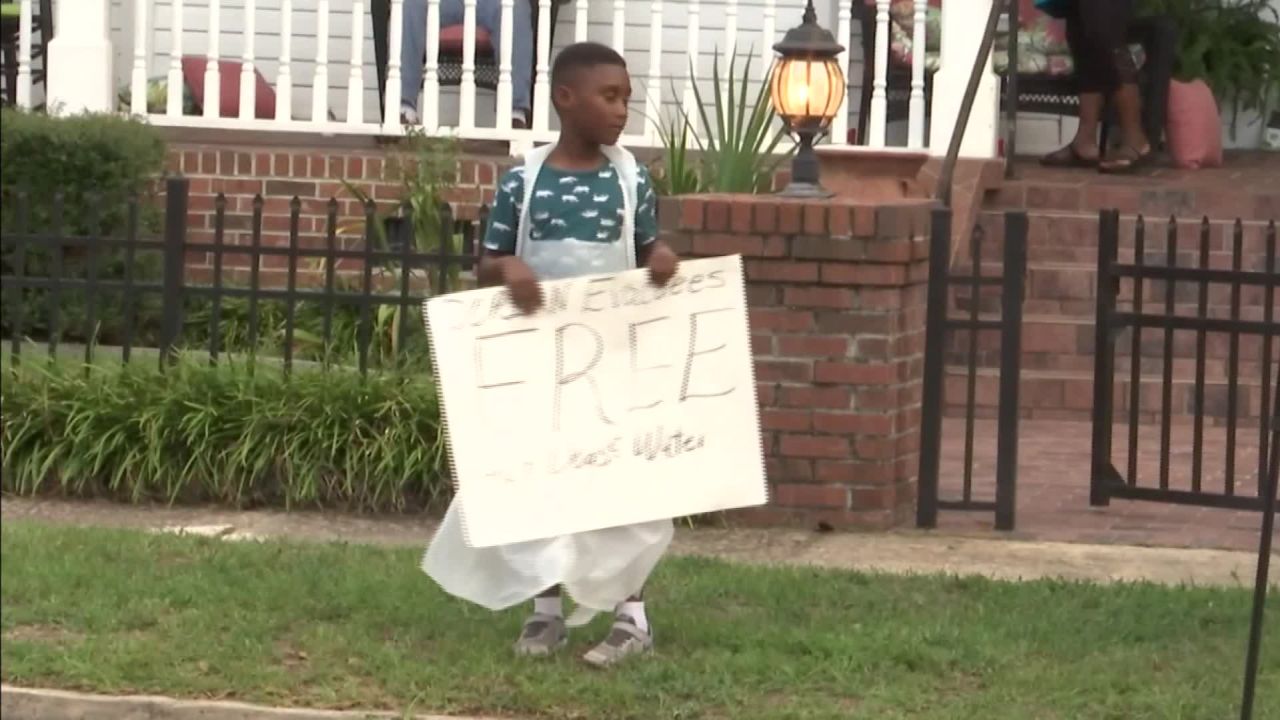 Jermaine Bell advertises free food and water for Hurricane Dorian evacuees.