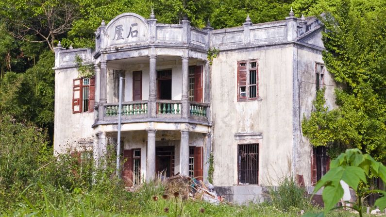 <strong>Abandoned mansion house, Fanling, New Territories East, Hong Kong</strong>: A formerly prestigious house near the border with mainland China pokes out of the dense subtropical foliage surrounding it with a sense of faded glamor.