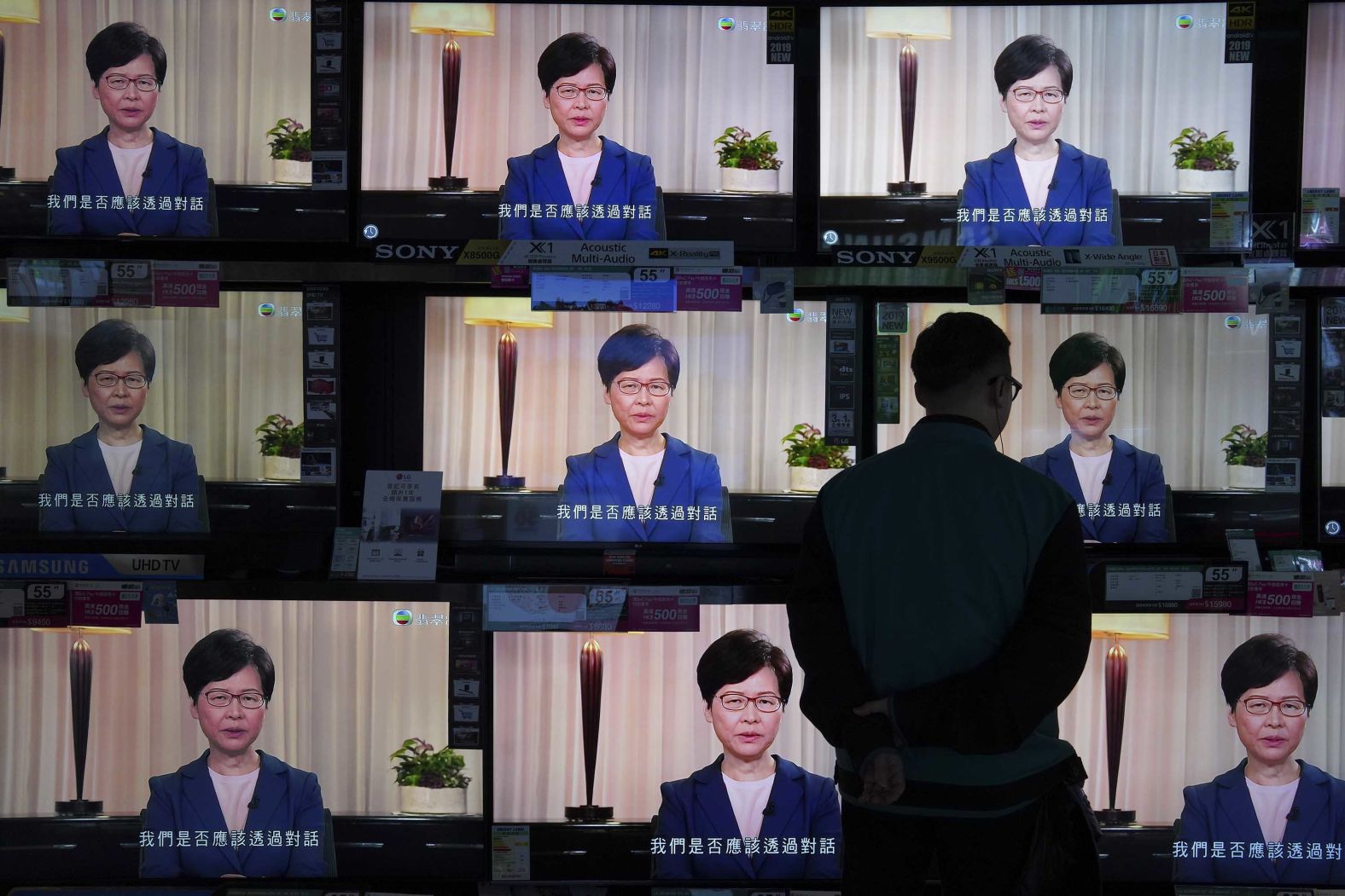 A man watches televisions at a store in Hong Kong as Chief Executive Carrie Lam announces the withdrawal of the extradition bill on Wednesday, September 4.