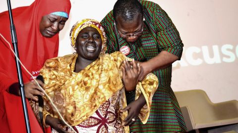 Rebeca Samuel (C), the mother of Sarah Samuel, one of the abducted Chibok girls, breaks down in tears while being helped by Coordinator of Bring Back Our Girls, Oby Ezekwesil (R), and Aisha Yesufu during a lecture in Abuja marking the third anniversary of the abduction in 2017. 