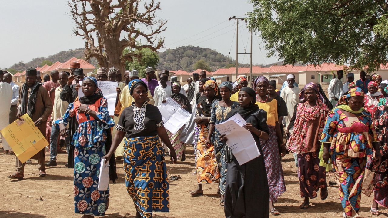 Parents and relatives arrives holding portraits of their girls for a commemoration five years after they were abducted by Boko Haram Jihadists group on April 14, 2019 at the Chibok Local Government.