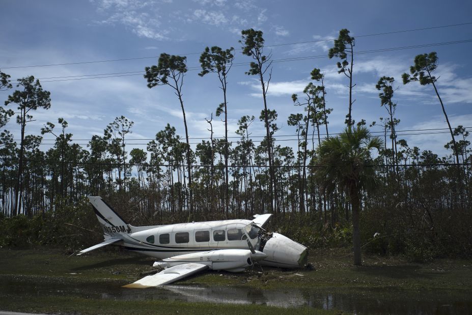 A broken plane rests on the side of a road in Freeport.