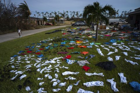 A child walks past clothes laid out to dry in Freeport, Bahamas, on September 4.