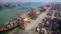 In this Aug. 6, 2019, photo, a container ship is docked a port in Qingdao in eastern China's Shandong province. U.S. President Donald Trump angrily escalated his trade fight with China on Friday, Aug. 23, 2019, raising retaliatory tariffs and ordering American companies to consider alternatives to doing business there. (Chinatopix via AP)