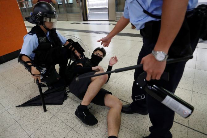 A protester is detained by police at the Po Lam Mass Transit Railway station on Thursday, September 5.