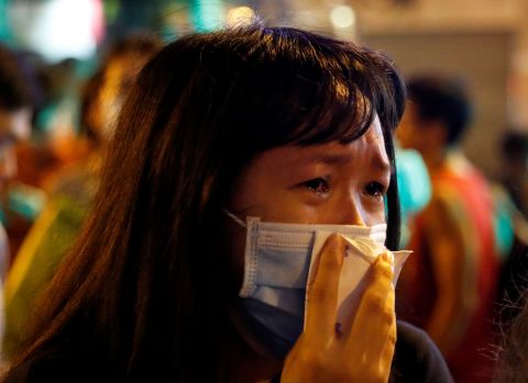 A woman gets emotional on September 4 while paying her respects to protesters who were injured a few days earlier.