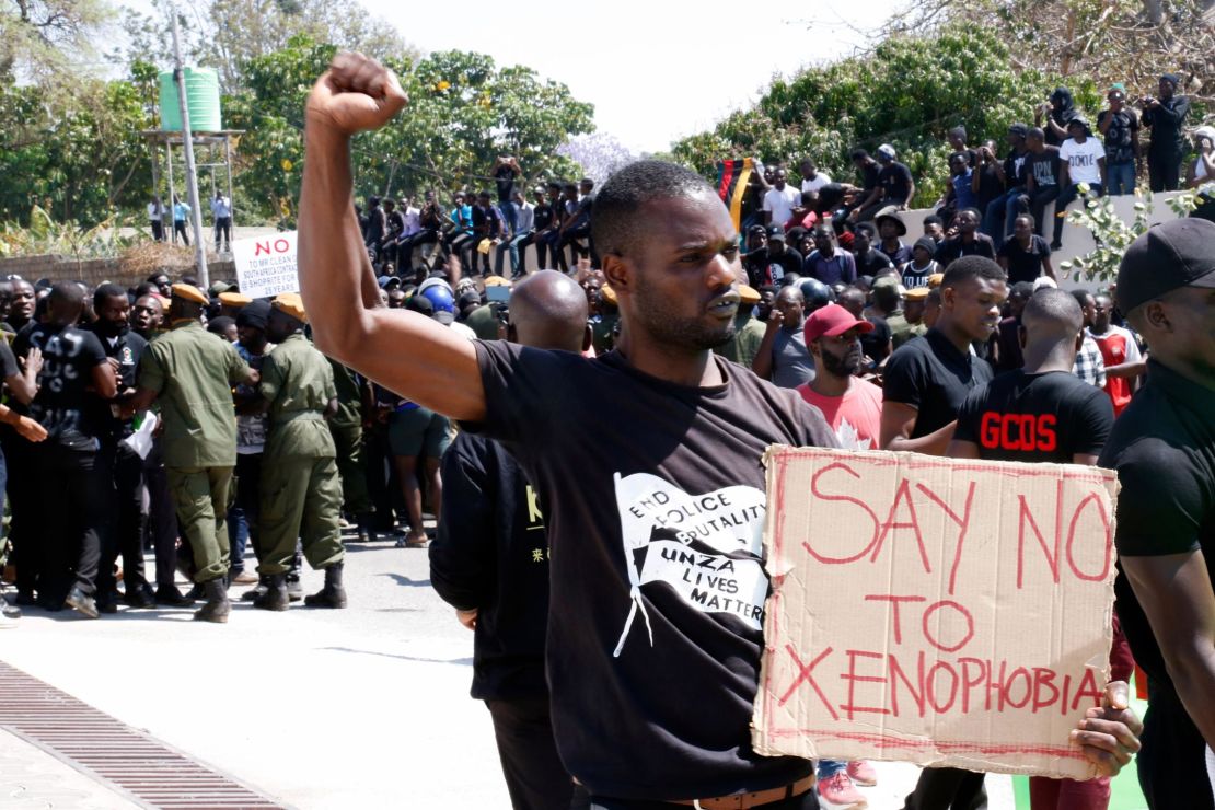 A protestor gestures and holds a placard during a demonstration in front of the South African Embassy in Lusaka, Zambia on September 4, 2019 