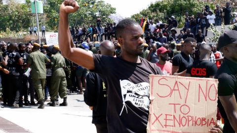 A protestor gestures and holds a placard during a demonstration in front of the South African Embassy in Lusaka, Zambia on September 4, 2019 