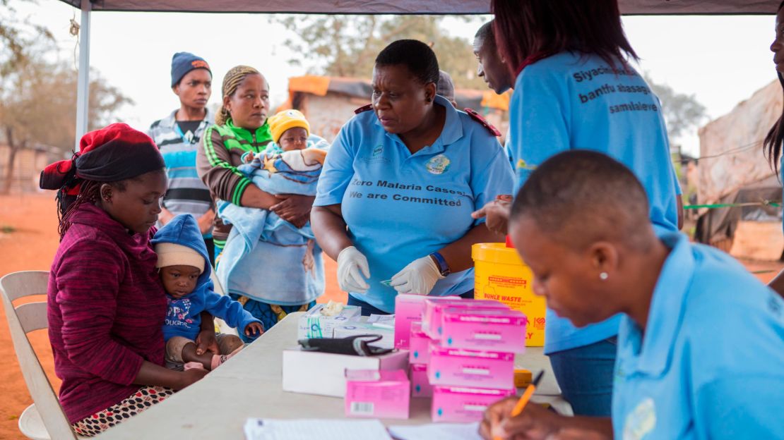 Health care workers test a mother and child for malaria at a border clinic in in Komatipoort, South Africa