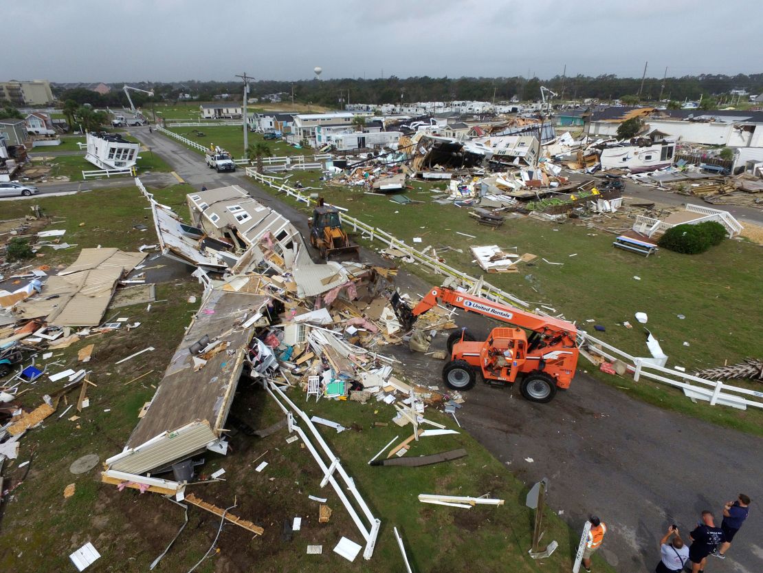 Emerald Isle town employees work to clear the road after a tornado hit Emerald Isle N.C. 