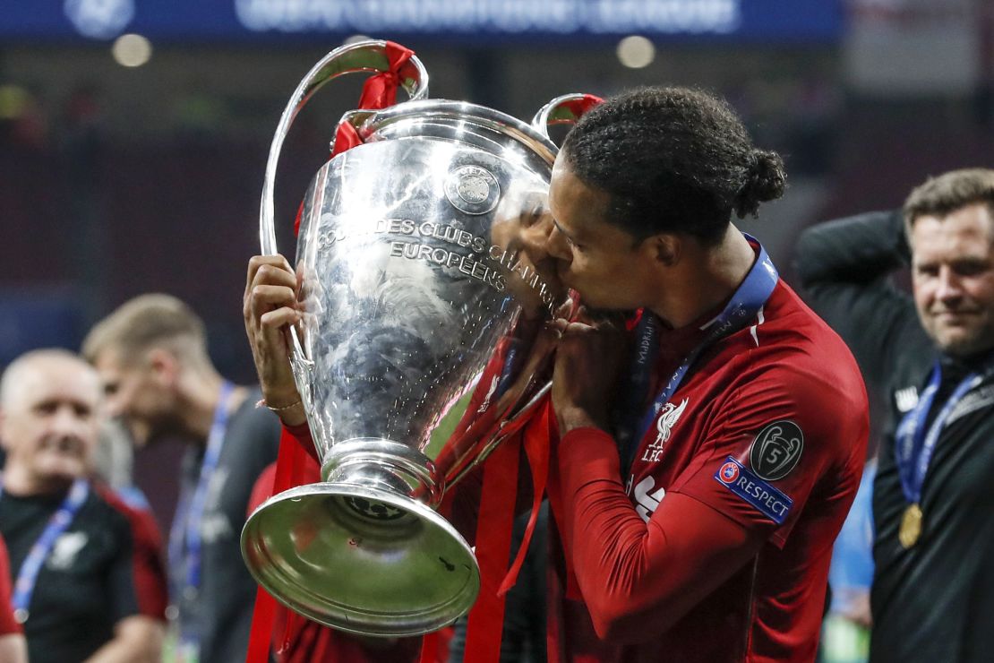 Liverpool's Virgil van Dijk kisses UEFA Champions League trophy. He was reported to have cost the club £75 million ($92.7 million) from Southampton.