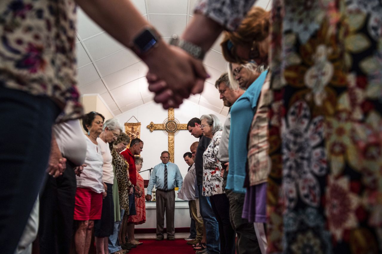 Members of the congregation at Elkmont United Methodist Church in Elkmont, Alabama, hold hands at a prayer vigil on Tuesday, September 3.<a href="https://www.cnn.com/2019/09/03/us/alabama-residence-shooting/index.html" target="_blank"> A 14-year-old has been charged</a> with five counts of murder after <a href="https://www.cnn.com/videos/us/2019/09/03/alabama-residence-shooting-newday-gingras-vpx.cnn" target="_blank">confessing to shooting</a> his family members in their home, police said Tuesday.