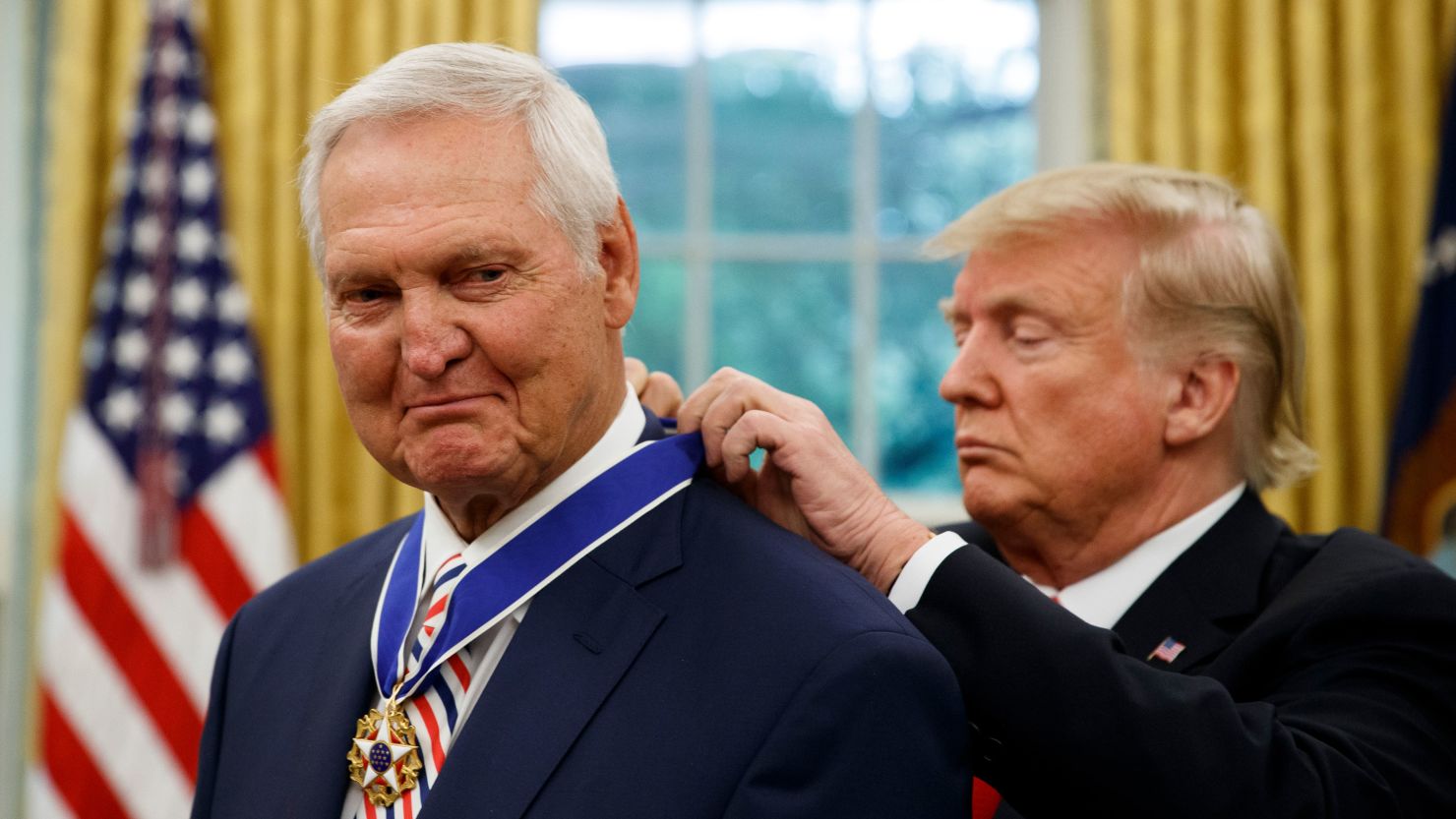 President Donald Trump presents the Presidential Medal of Freedom to former NBA basketball player and general manager Jerry West, in the Oval Office of the White House, Thursday, September 5, 2019. 