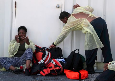 A woman from the Bahamas speaks on a cell phone after evacuating on September 5. 