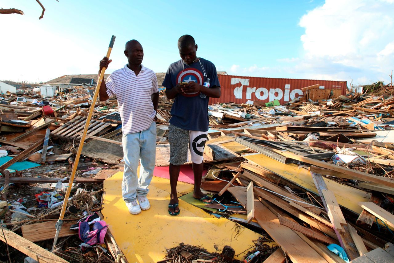 Two men stand amid the destruction in Marsh Harbour, Bahamas, on September 5.