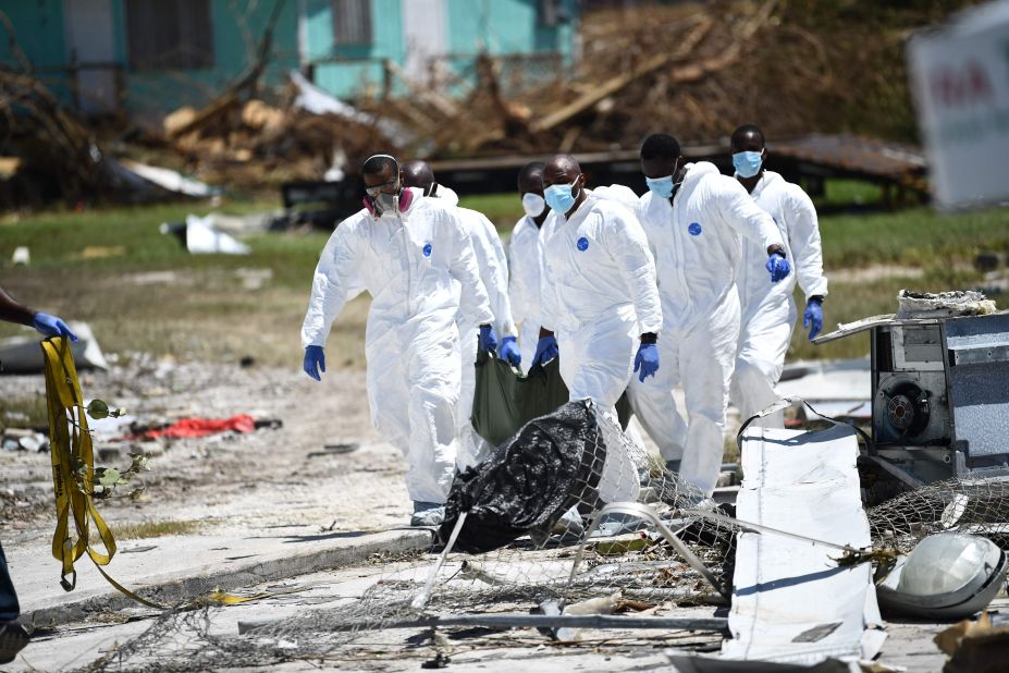 Rescue workers recover a body in Marsh Harbour on September 5.