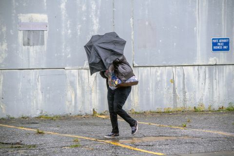 A woman battles rain and wind in Charleston, South Carolina, on September 5. 