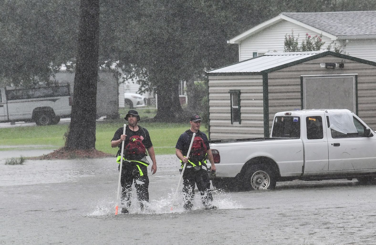 Rescue workers walk through floodwaters in Little River, South Carolina, on September 5.