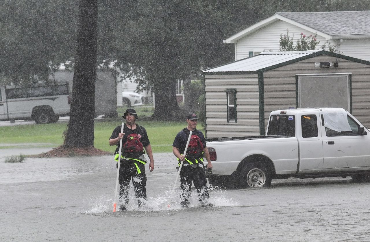 Rescue workers walk through floodwaters in Little River, South Carolina, on September 5. 