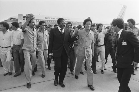 Mugabe holds hands with Libyan leader Moammar Gadhafi at the Organization of African Unity summit in August 1982.