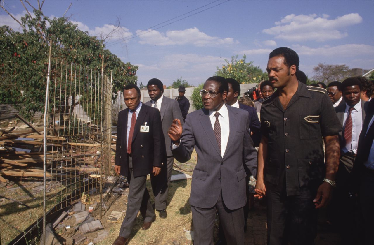Mugabe walks hand in hand with American civil rights activist Jesse Jackson during the Summit of Non-Aligned Countries, which Harare hosted in 1986.