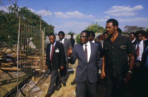 Mugabe walks hand in hand with American civil rights activist Jesse Jackson during the Summit of Non-Aligned Countries, which Harare hosted in 1986.