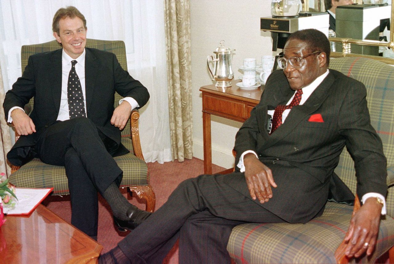 British Prime Minister Tony Blair talks with Mugabe in October 1997, before the start of the Commonwealth Heads of Government meeting.
