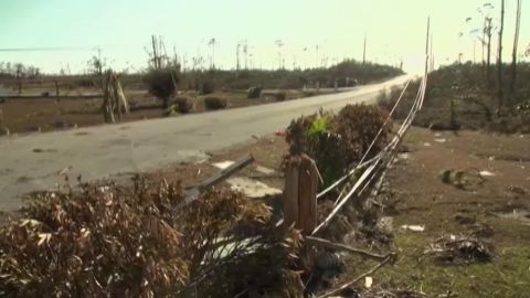 Downed power lines lie along the road into town.