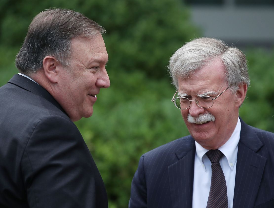 Mike Pompeo talks with  John Bolton before a in  Rose Garden news conference in June 2018.