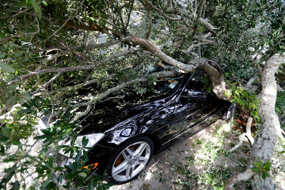 A fallen tree lies on top of a vehicle in Isle of Palms, South Carolina, on September 6.