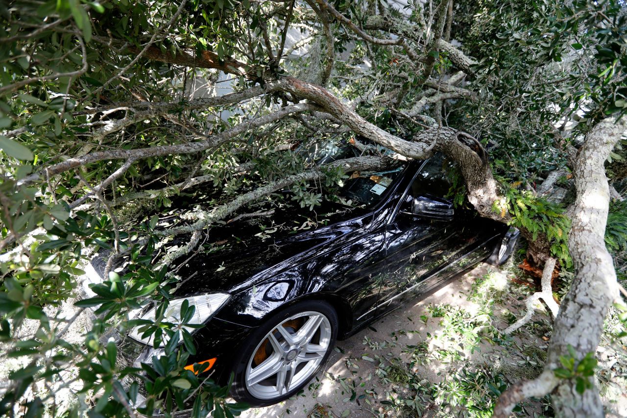 A fallen tree lies on top of a vehicle in Isle of Palms, South Carolina, on September 6.