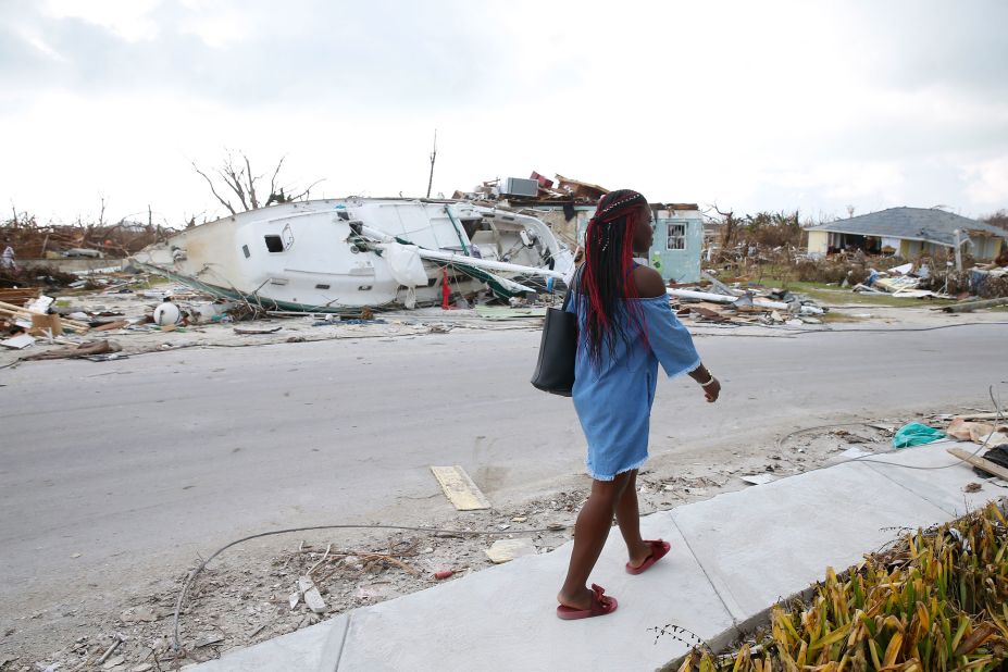 Schemelda Saintilien walks past debris and damaged houses on the Bahamas' Great Abaco island.