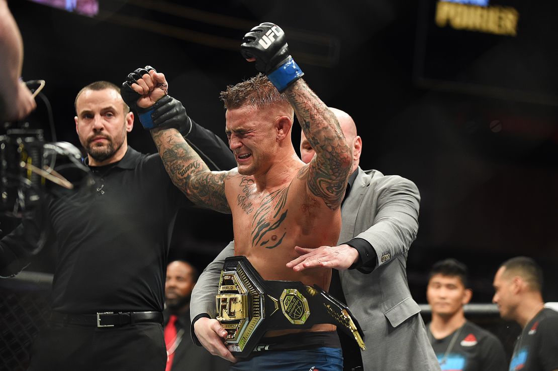 Dustin Poirier celebrates after recieving the title belt from UFC President Dana White.