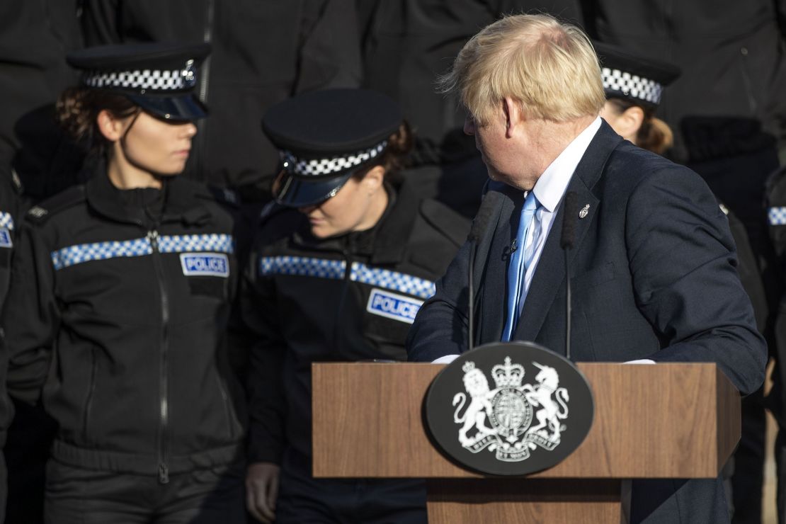 Britain's Prime Minister Boris Johnson reacts as an officer fell unwell during his speech.