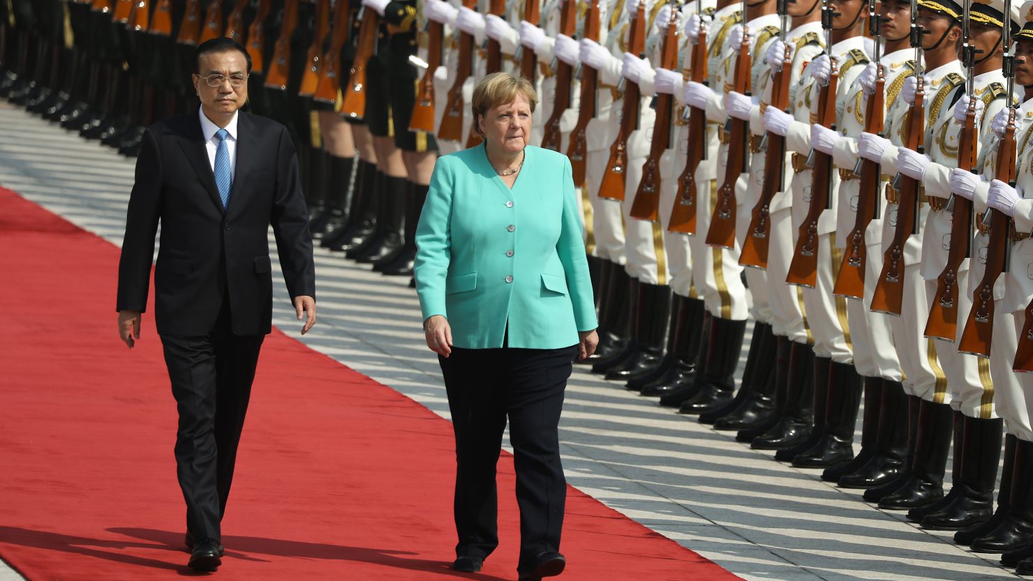 Chinese Premier Li Keqiang and Chancellor of Germany Angela Merkel review the Guard of Honour of the People's Liberation Army at The Great Hall Of The People on September 6 in Beijing.