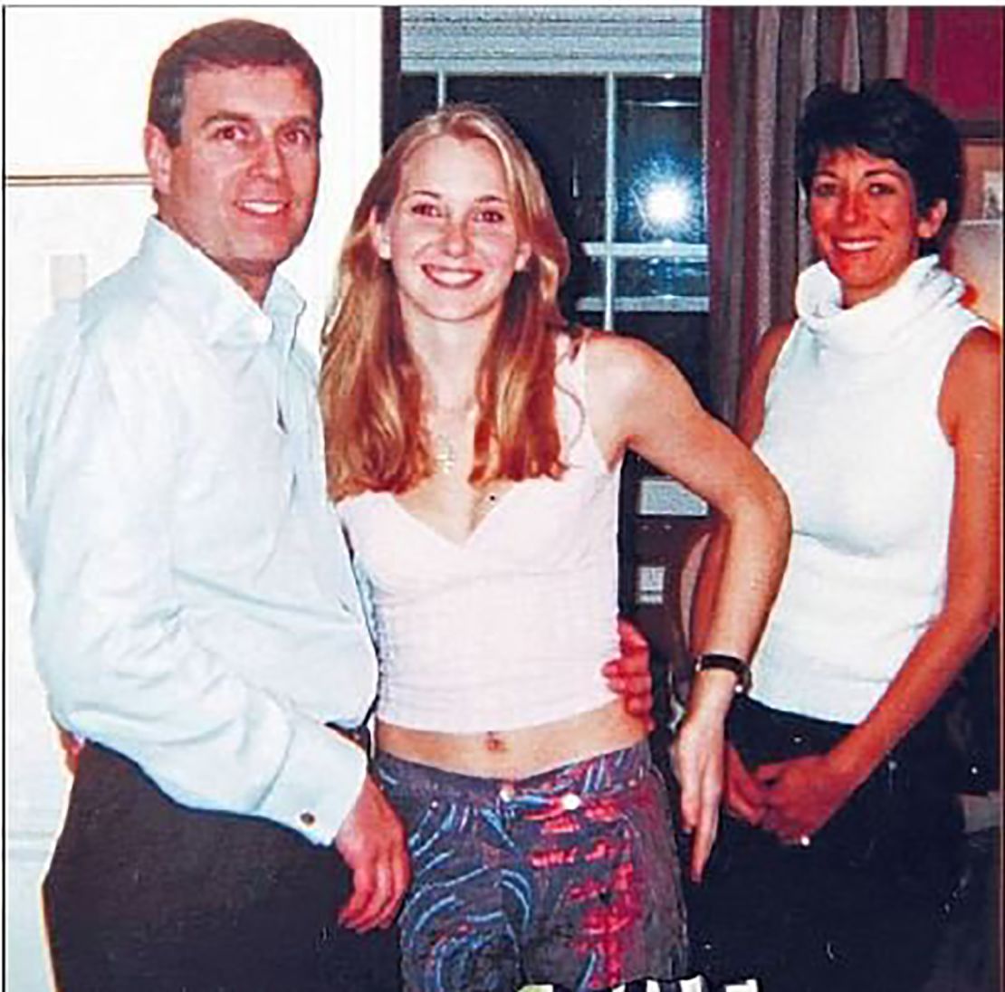 A photograph appearing to show Prince Andrew with Jeffrey Epstein accuser Virginia Giuffre and, in the background, Ghislaine Maxwell.