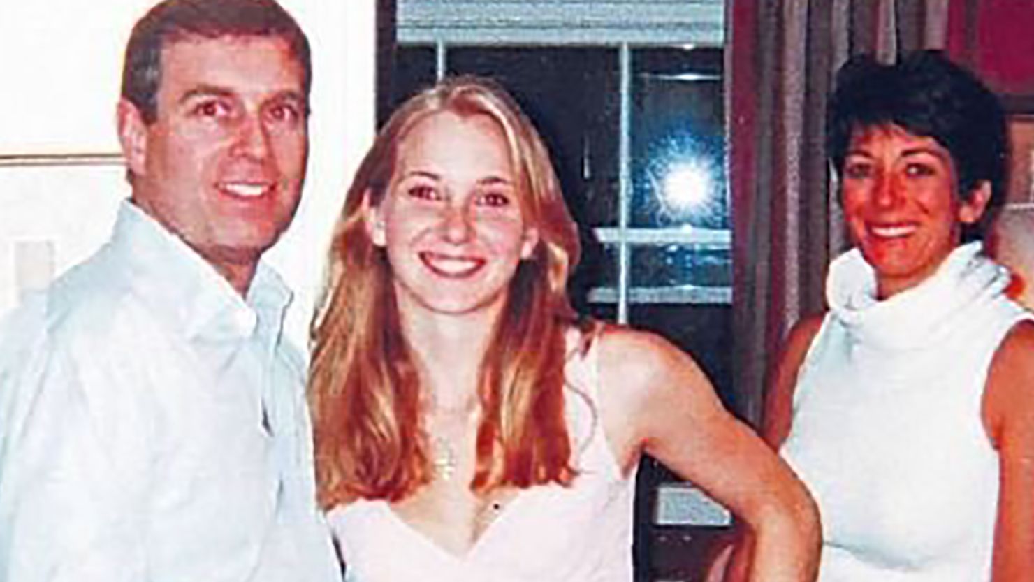 A photograph appearing to show Prince Andrew, the Duke of York, with Jeffrey Epstein's accuser Virginia Roberts Giuffre and, in the background, Ghislaine Maxwell.