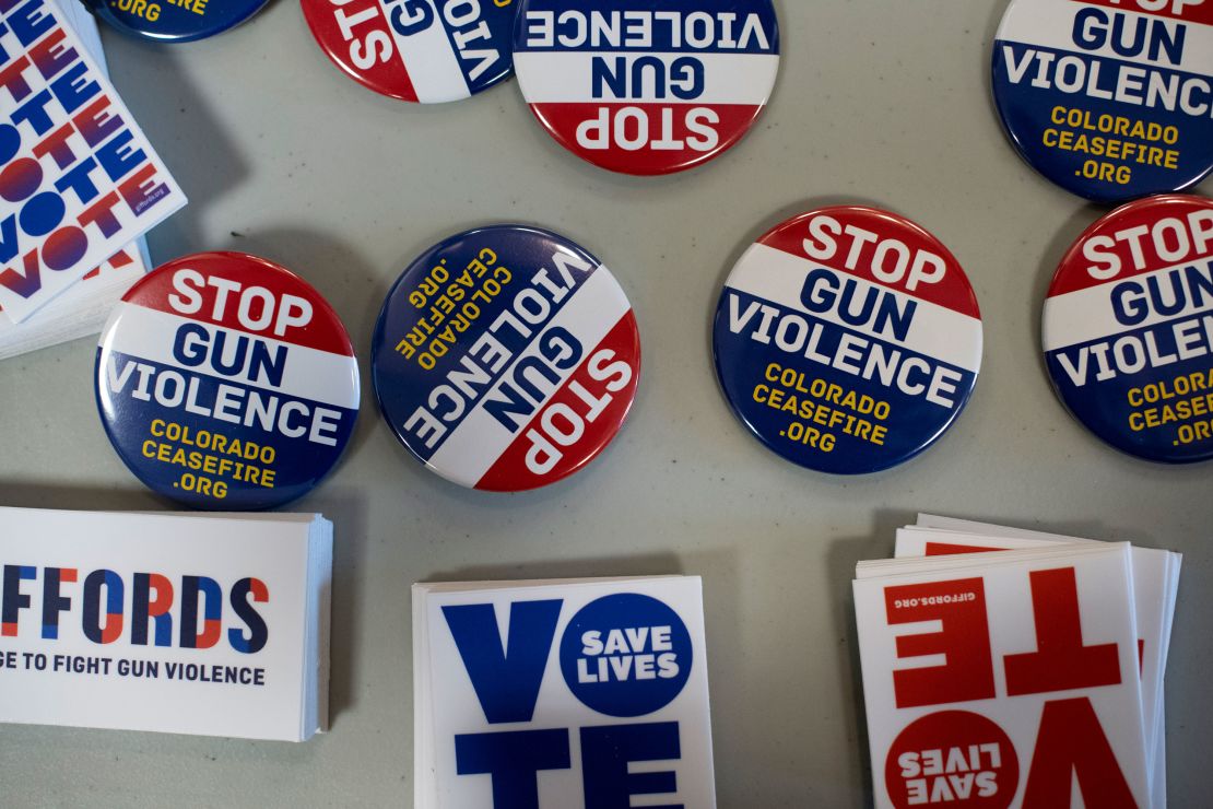 Pins and stickers advocating to stop gun violence are on display during the Gun Safety Town Hall on Monday, August 26 in Aurora, Colorado.