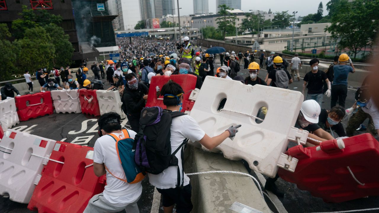 Protesters move barricades to block a street during the June 12 protest.