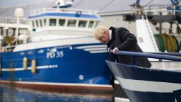 Britain's Prime Minister Boris Johnson looks to the water from a boat during a visit to Scotland.