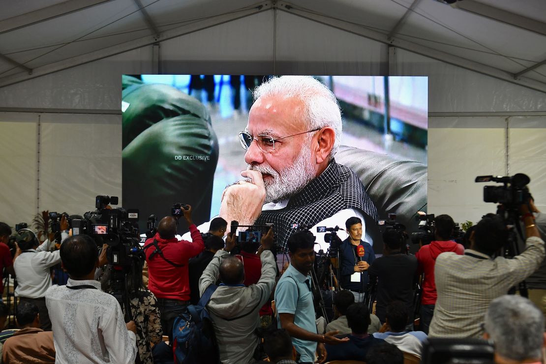 Prime Minister Narendra Modi is seen on TV as he watches the live broadcast of the soft landing.