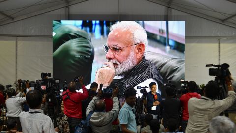 Prime Minister Narendra Modi is seen on TV as he watches the live broadcast of the soft landing.