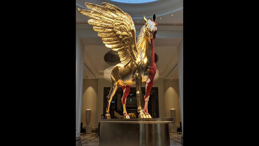 <strong>Welcome: </strong>Damien Hirst's "Legend" on a pedestal in gold and flayed, gory red (because: Damien Hirst) greets visitors, setting the tone for the over-the-top property.