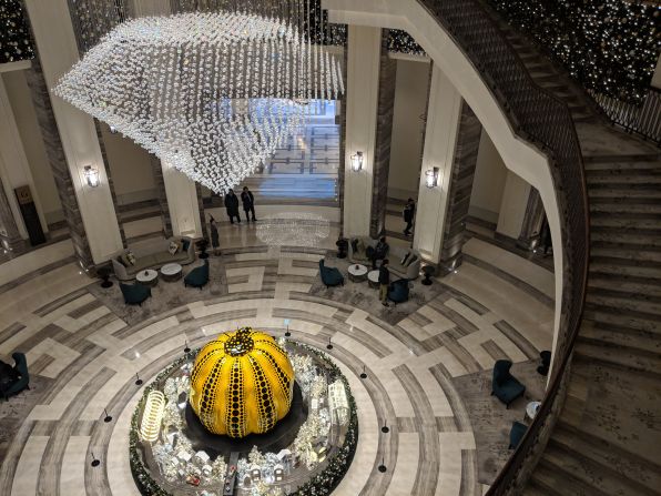 <strong>A lobby like no other:</strong> Yayoi Kusama's giant glass polka-dotted pumpkin sits confidently under a crystal chandelier in the center of the resort's main lobby area. <br />