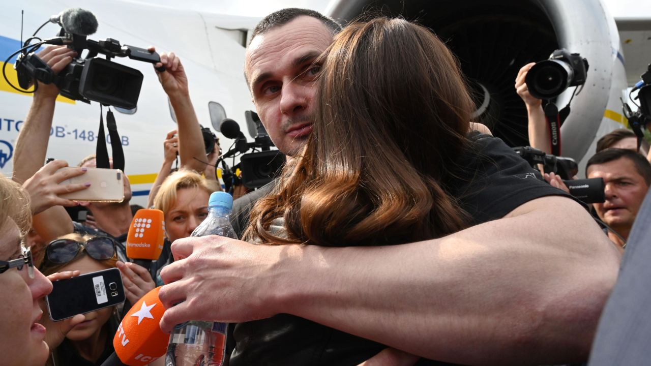 Ukrainian film director Oleg Sentsov hugs his daughter after arriving back in Kiev .